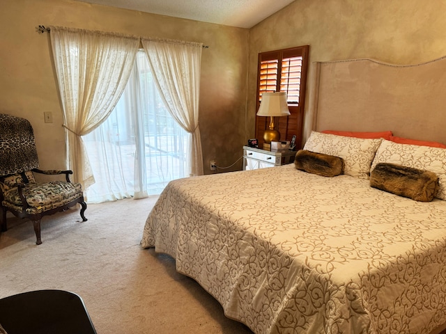 carpeted bedroom featuring a textured ceiling and vaulted ceiling