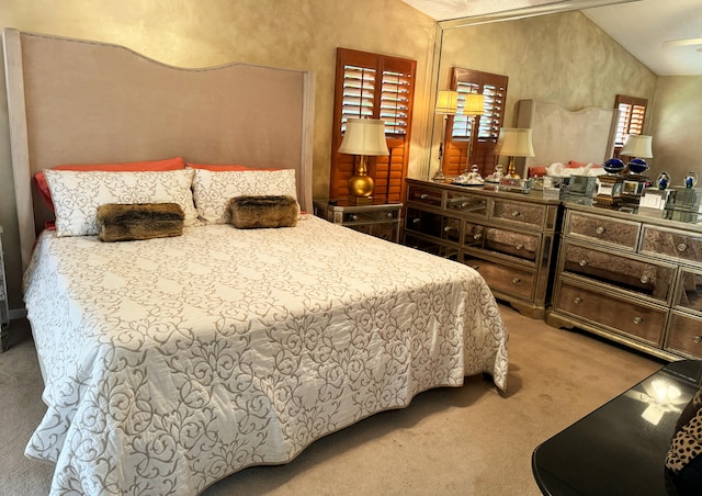 bedroom featuring carpet and vaulted ceiling