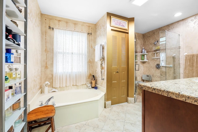 bathroom with vanity and separate shower and tub