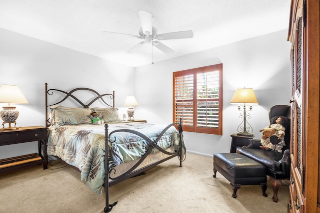 bedroom featuring ceiling fan and carpet