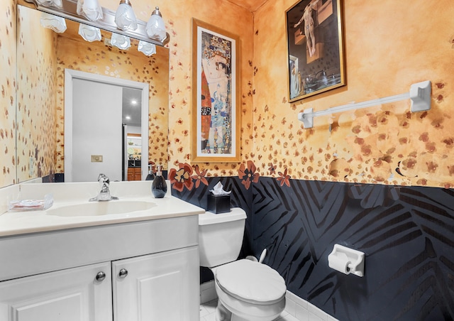 bathroom featuring tile patterned floors, vanity, and toilet