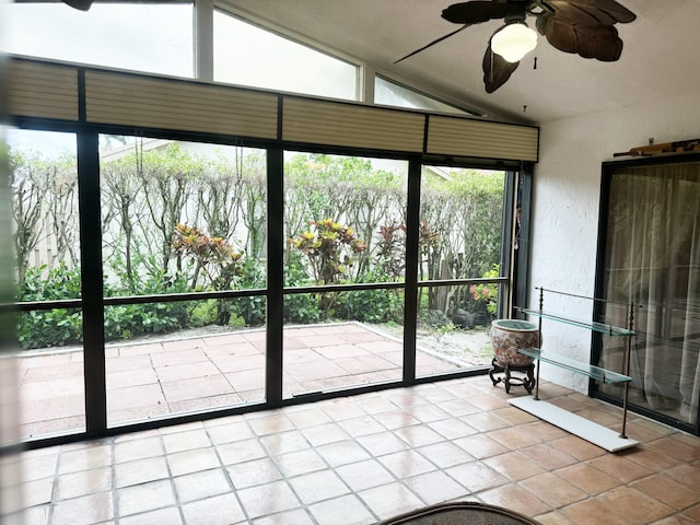 unfurnished sunroom with ceiling fan and lofted ceiling