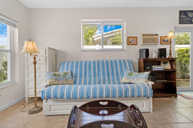 living room with light tile patterned floors and a wall mounted AC