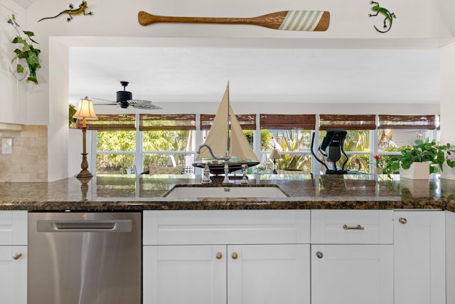 kitchen with dishwasher, backsplash, white cabinets, and dark stone counters