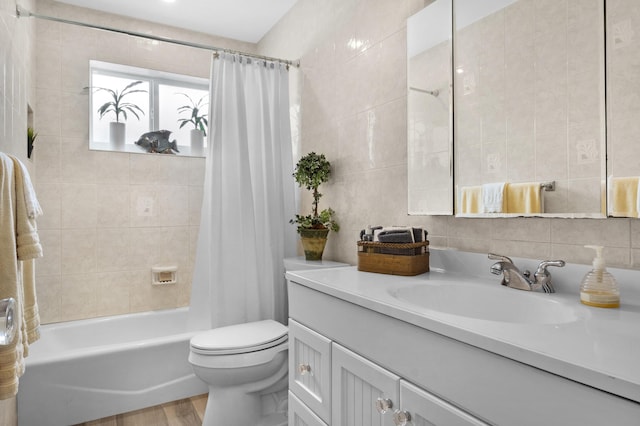 full bathroom with tile walls, wood-type flooring, shower / bath combo, and toilet