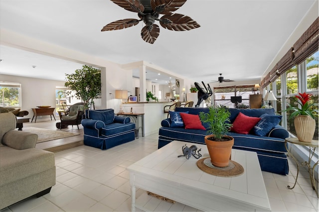 living room with ceiling fan, light tile patterned floors, and a wealth of natural light