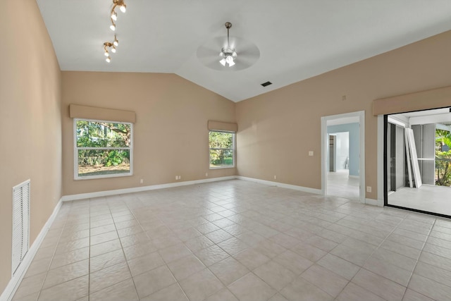 tiled spare room with ceiling fan, track lighting, and vaulted ceiling