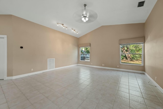 tiled spare room featuring ceiling fan and vaulted ceiling