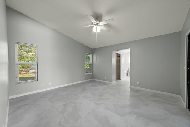 unfurnished room with ceiling fan, a healthy amount of sunlight, and lofted ceiling