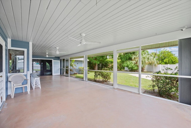 unfurnished sunroom with ceiling fan and french doors