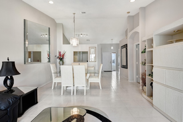 tiled dining area with an inviting chandelier