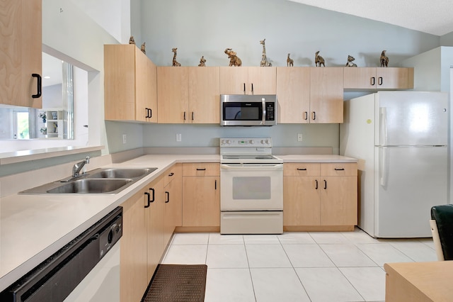 kitchen with light brown cabinets, lofted ceiling, light tile patterned flooring, sink, and white appliances