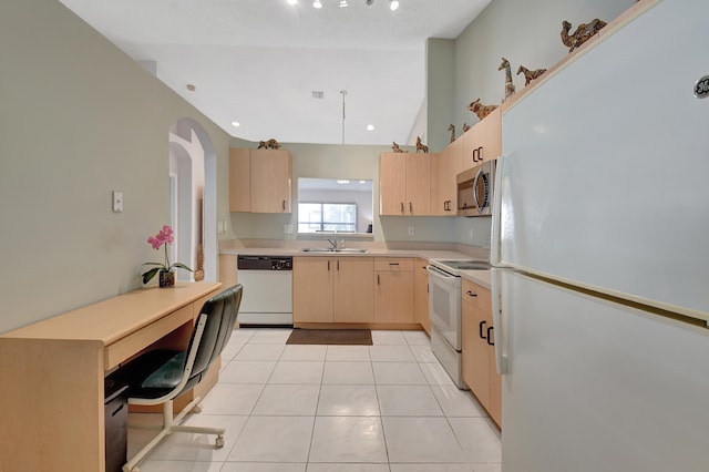 kitchen with white appliances, light brown cabinetry, sink, lofted ceiling, and light tile patterned floors