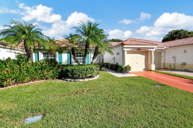 mediterranean / spanish house with a front yard and a garage