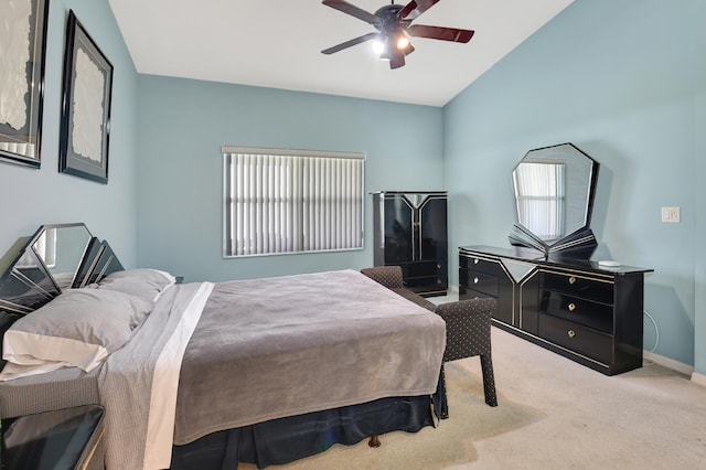 carpeted bedroom with ceiling fan, lofted ceiling, and multiple windows