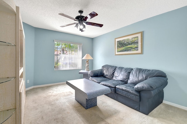 carpeted living room with a textured ceiling and ceiling fan