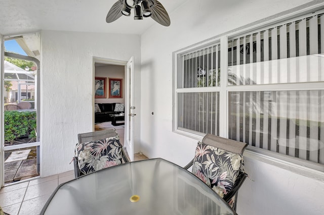 interior space with tile patterned floors and ceiling fan