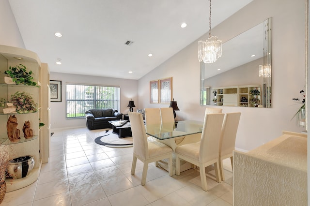 dining room with light tile patterned floors and vaulted ceiling