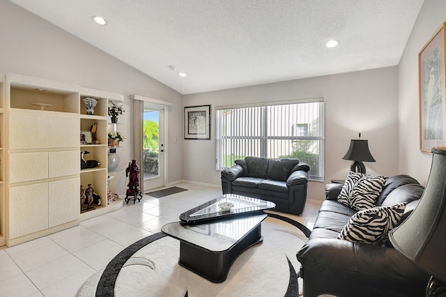 tiled living room featuring a textured ceiling and lofted ceiling