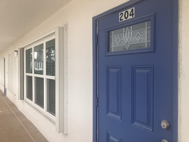 doorway to property with stucco siding