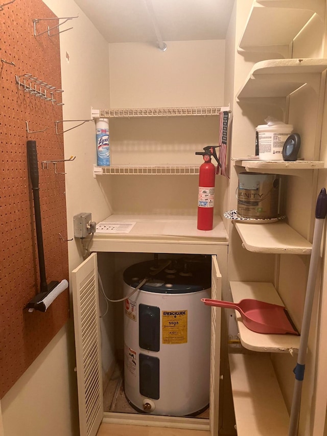 utility room featuring electric water heater