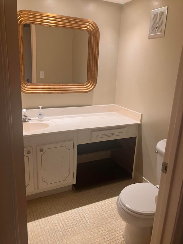 bathroom featuring vanity, toilet, and tile patterned floors