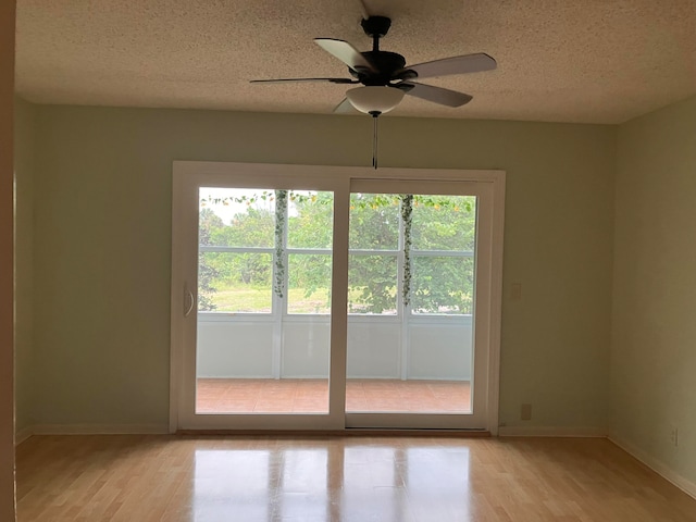 interior space with ceiling fan, a textured ceiling, and light hardwood / wood-style flooring