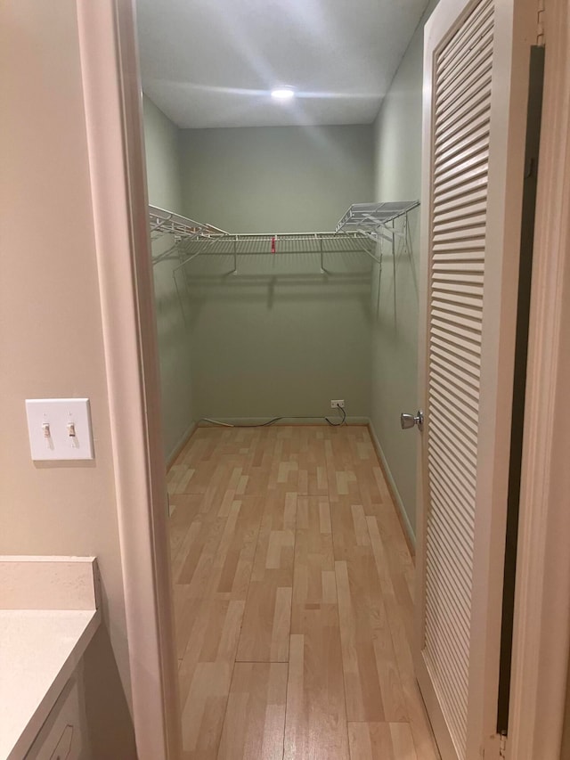 spacious closet with light hardwood / wood-style floors