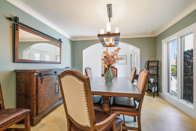 dining area featuring ornamental molding, light tile patterned floors, and a barn door