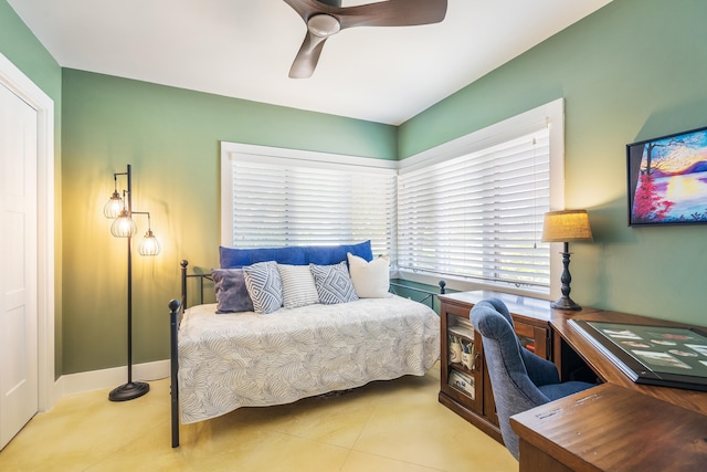 tiled bedroom featuring ceiling fan