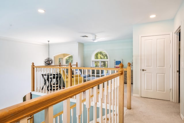 hallway featuring light colored carpet