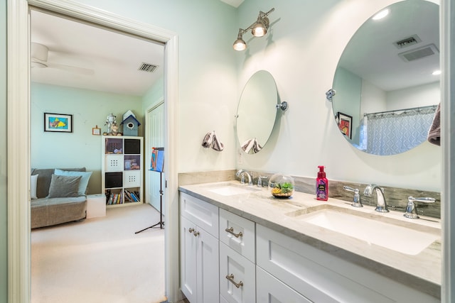 bathroom featuring ceiling fan and double vanity