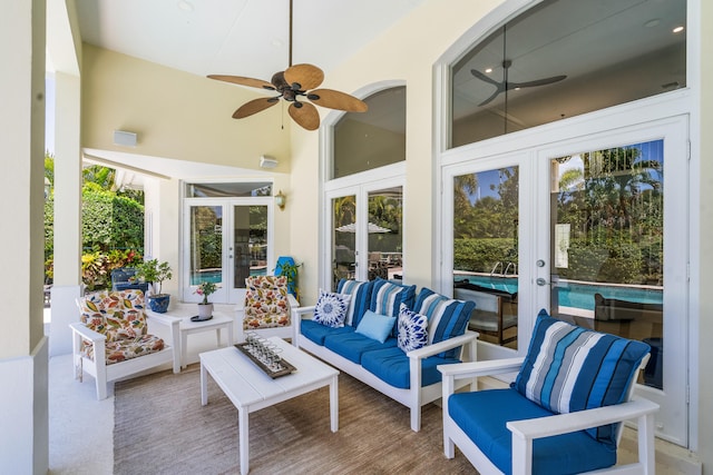 sunroom with ceiling fan, french doors, and lofted ceiling