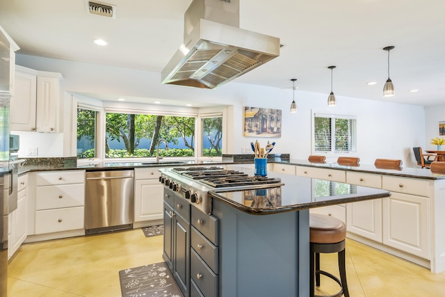 kitchen with appliances with stainless steel finishes, decorative light fixtures, island range hood, white cabinetry, and gray cabinetry