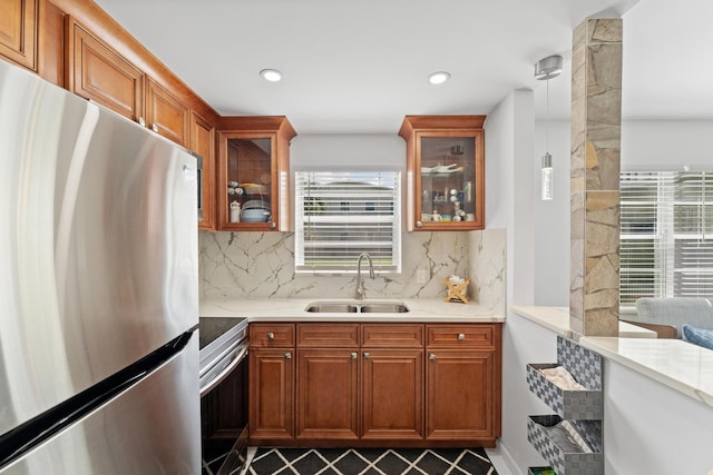 kitchen featuring tile patterned flooring, tasteful backsplash, electric range oven, sink, and stainless steel fridge