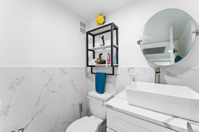 bathroom featuring visible vents, vanity, and toilet