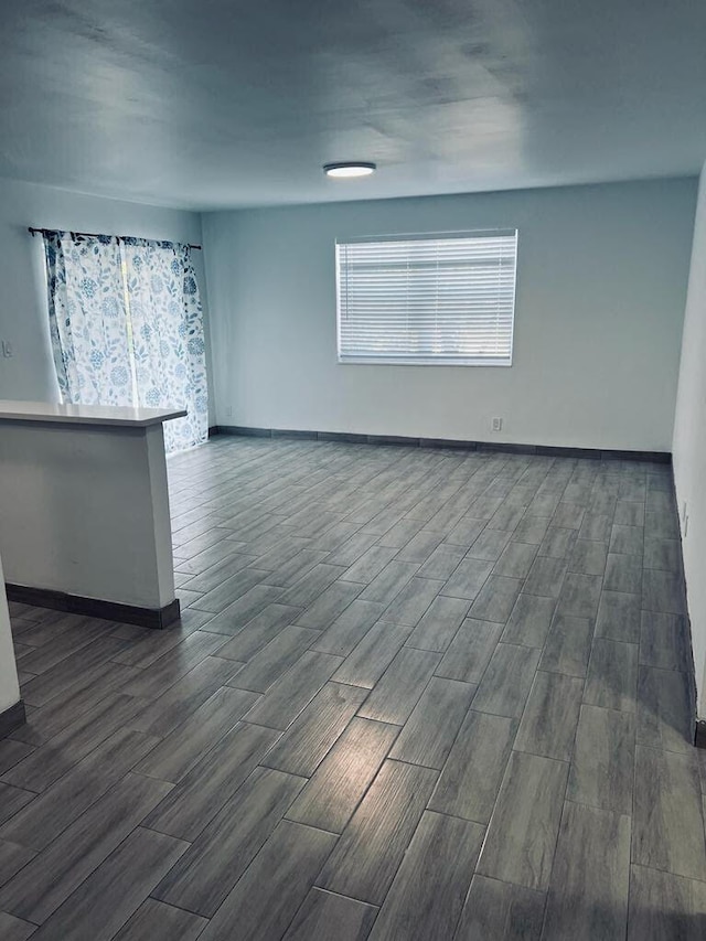 interior space with wood tiled floor and baseboards