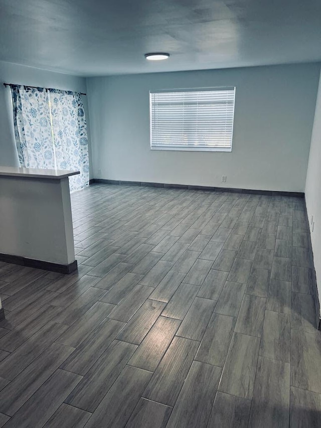 spare room with baseboards and wood tiled floor