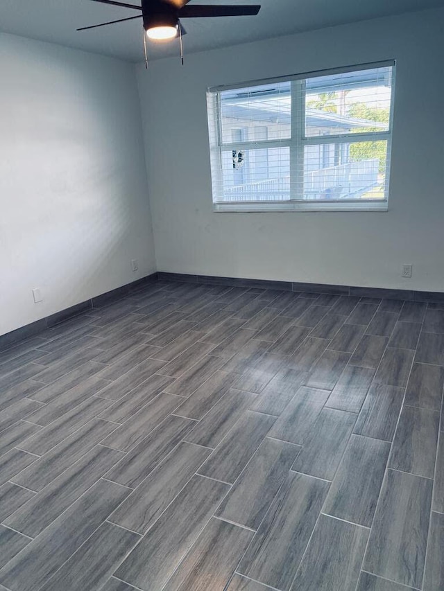 unfurnished room featuring a ceiling fan and wood tiled floor