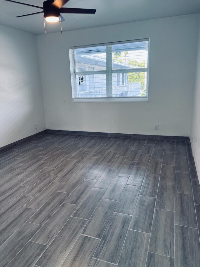 empty room with ceiling fan and wood finish floors