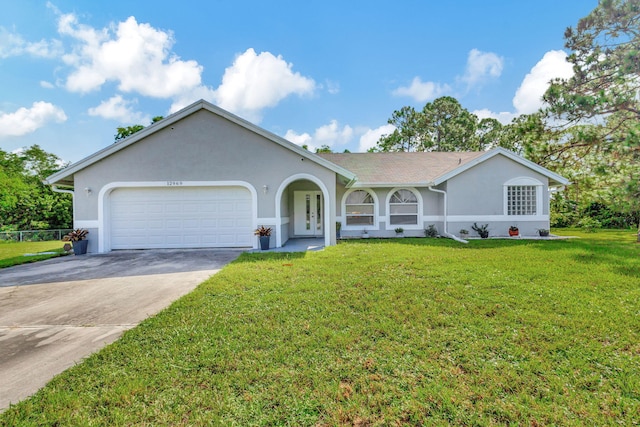 ranch-style home with a garage and a front lawn