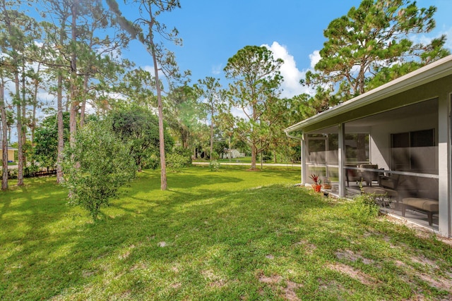 view of yard with a sunroom