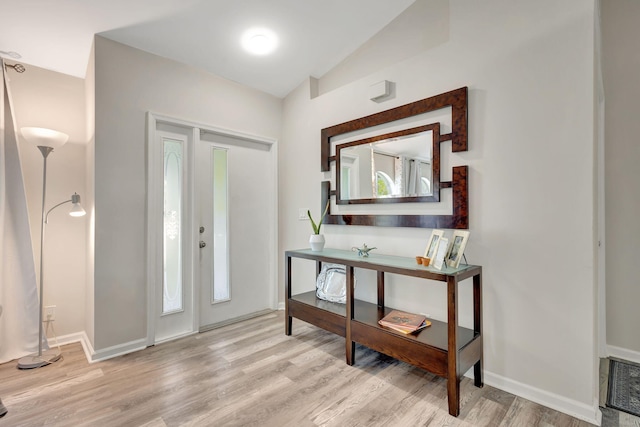 entryway featuring light hardwood / wood-style floors and lofted ceiling