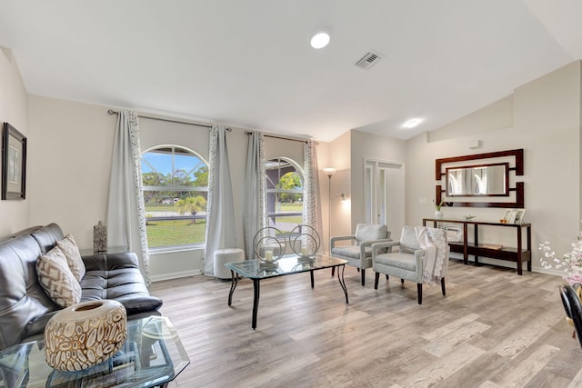 living room featuring light hardwood / wood-style flooring and lofted ceiling