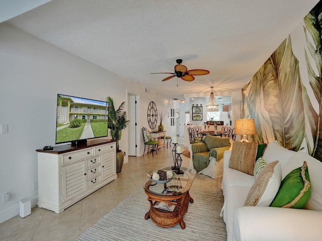 tiled living room with ceiling fan and a textured ceiling