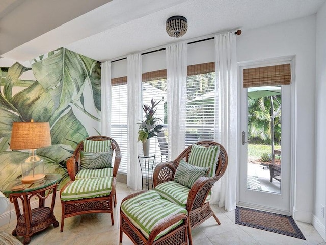 sitting room with a textured ceiling and light tile patterned floors