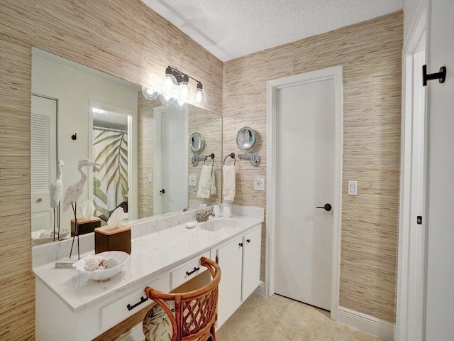 bathroom featuring tile patterned floors, a textured ceiling, and dual vanity