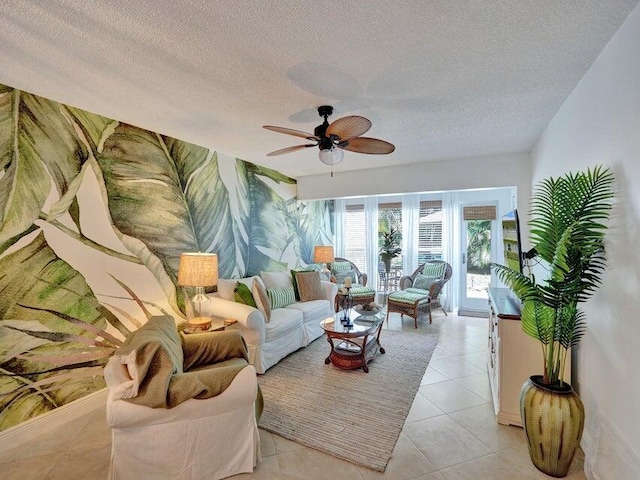 living room with a textured ceiling, ceiling fan, and light tile patterned flooring