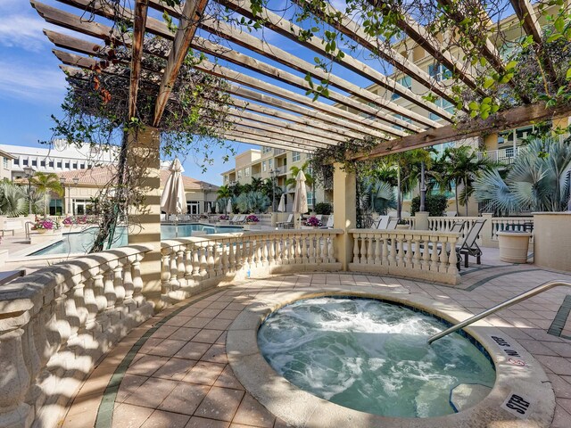 view of swimming pool with a pergola, a hot tub, and a patio area