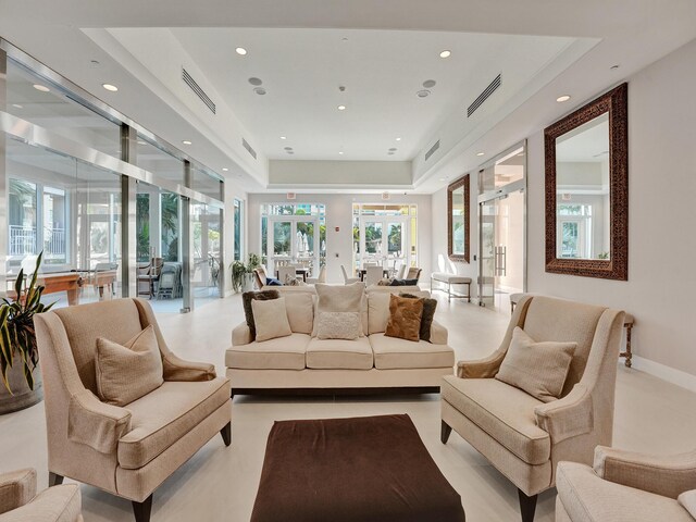 interior space with french doors and a tray ceiling